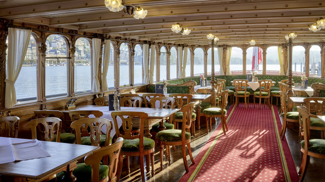 Dampfschiff Unterwalden - Hauptdeck Der nostalgische Salon des Dampfschiffes Unterwalden mit weiss gedeckten Tischen.