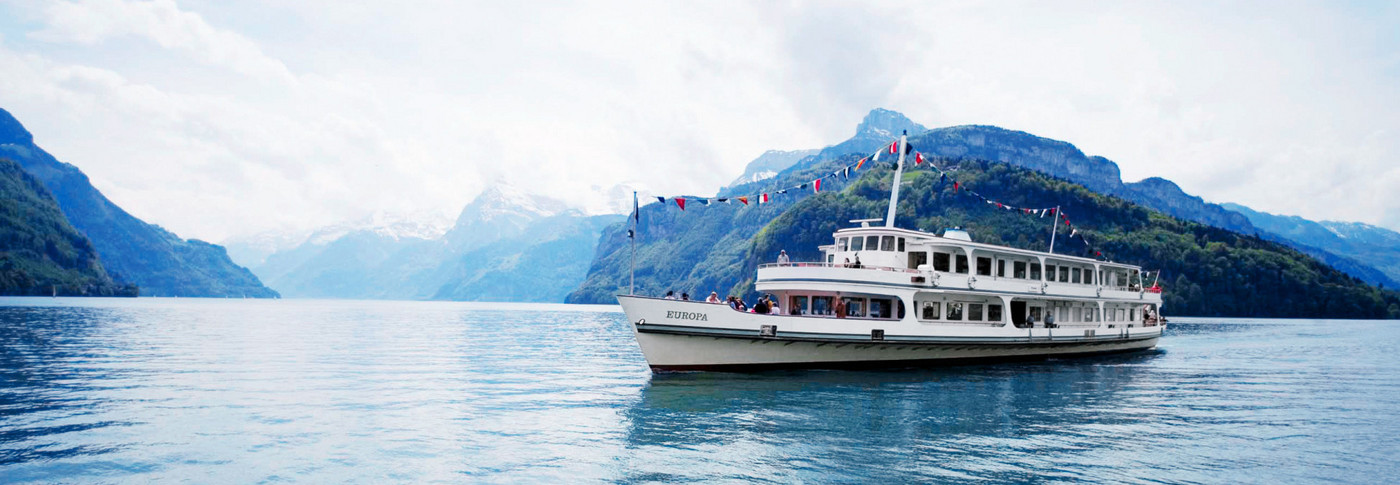 The motor vessel Europa with fixed flags during a cruise on Lake Lucerne.