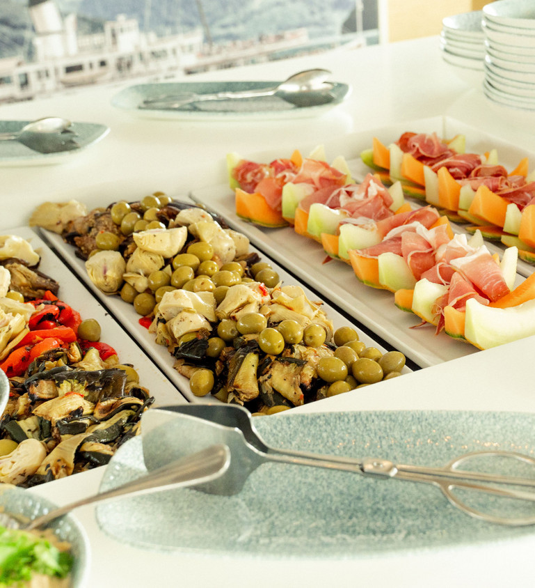Diverses salades de saison faites maison, des crudités régionales et des salades vertes sont servies fraîches sur le buffet.